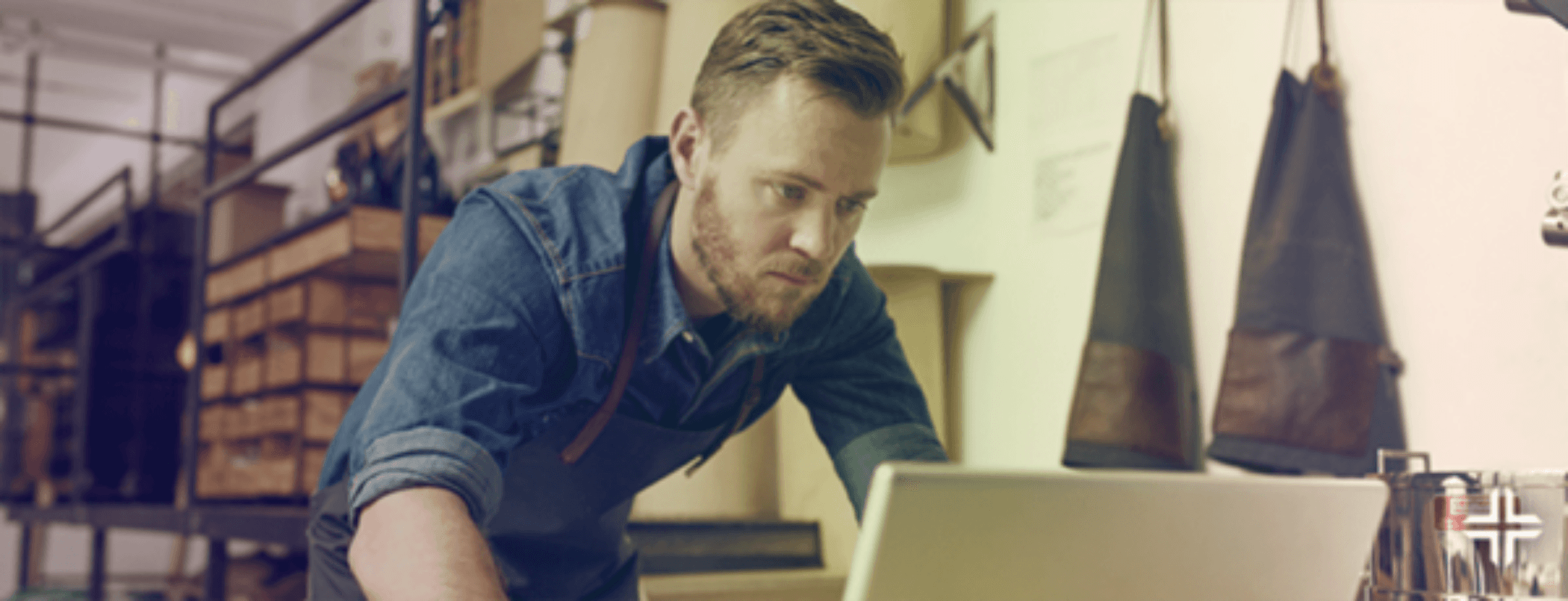 Man working at a store using a computer