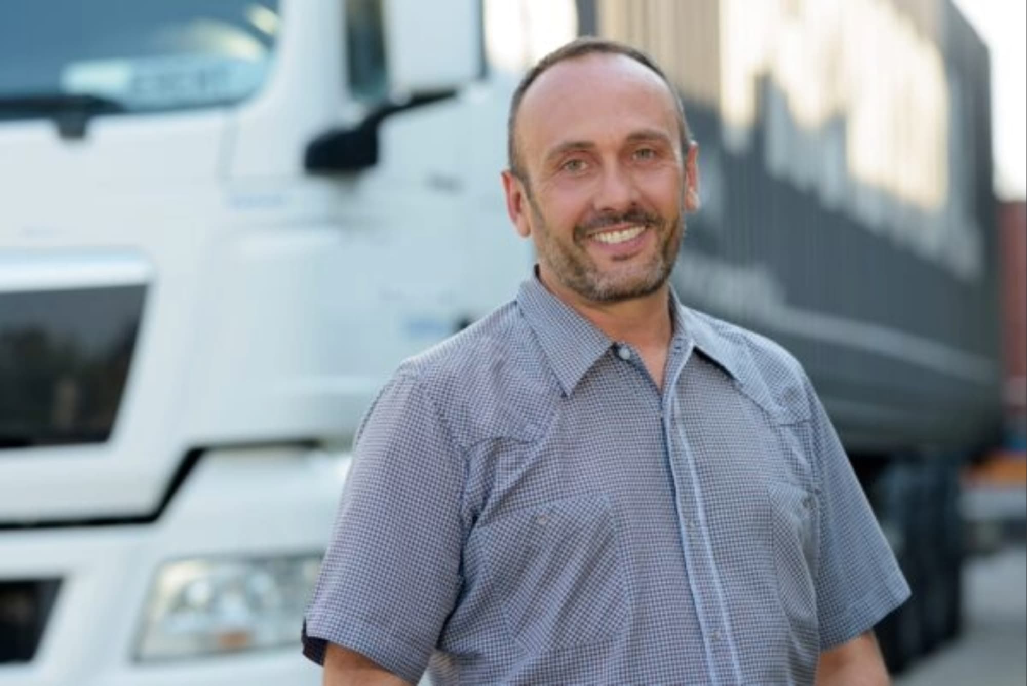 man standing by his truck